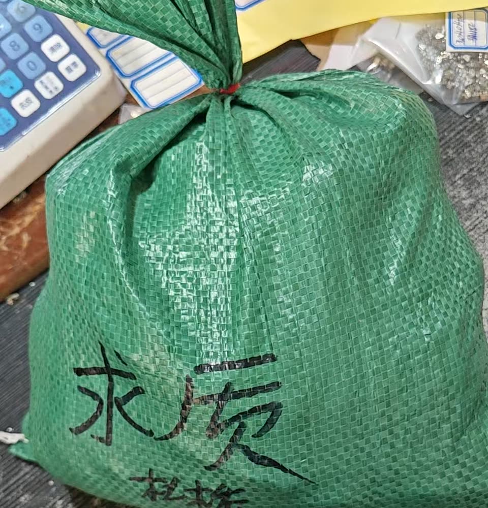 A finished order packed in a woven bag, marked and weighed for shipping